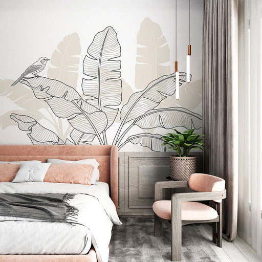 Une chambre moderne avec un papier peint représentant de grandes feuilles tropicales en noir et beige, créant une atmosphère apaisante et naturelle.