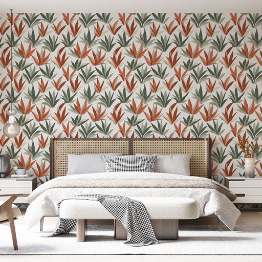 Une chambre moderne avec un papier peint aux motifs botaniques dans des teintes de vert et d'orange sur fond clair, créant une ambiance chaleureuse et naturelle.