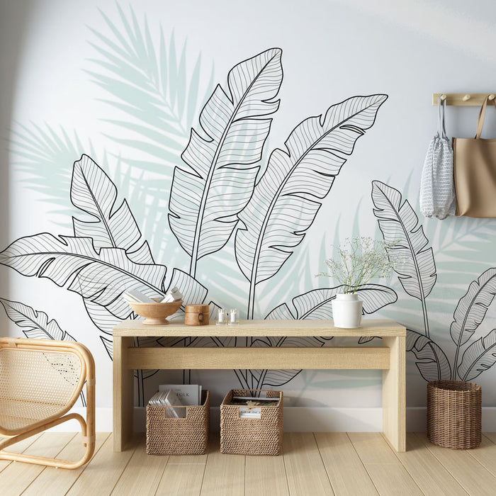 Une pièce lumineuse avec un papier peint représentant des feuilles tropicales en noir sur fond clair, créant une ambiance fraîche et moderne.