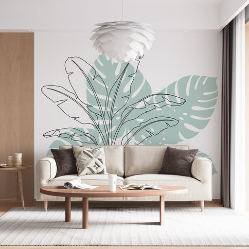 Un salon moderne avec un papier peint tropical représentant de grandes feuilles stylisées en vert pastel sur fond blanc, créant une ambiance fraîche et apaisante.