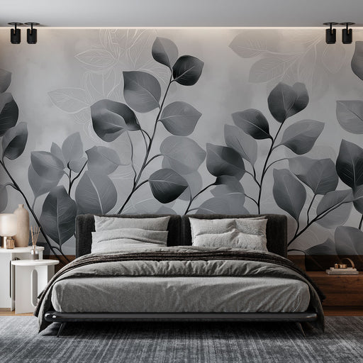 Une chambre moderne avec un papier peint aux motifs de feuilles en dégradé de gris, créant une atmosphère apaisante et élégante.
