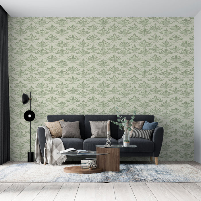 Un salon contemporain avec un papier peint aux motifs de feuilles stylisées vertes sur fond clair, créant une atmosphère fraîche et apaisante.
