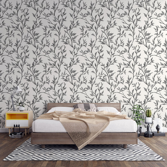 Une chambre moderne avec un papier peint floral noir et blanc représentant des branches délicates, créant une atmosphère apaisante et élégante.