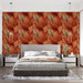 Une chambre moderne avec un papier peint aux motifs de grandes feuilles dans des teintes chaudes de rouge et orange, créant une atmosphère chaleureuse et accueillante.
