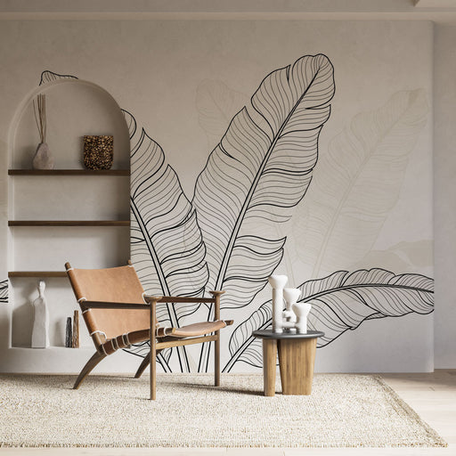 Une pièce lumineuse avec un papier peint représentant de grandes feuilles tropicales en lignes noires sur un fond clair, créant une ambiance naturelle et apaisante.