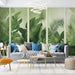 Un salon moderne avec un papier peint tropical aux nuances de vert, représentant de grandes feuilles luxuriantes qui créent une ambiance apaisante et naturelle.