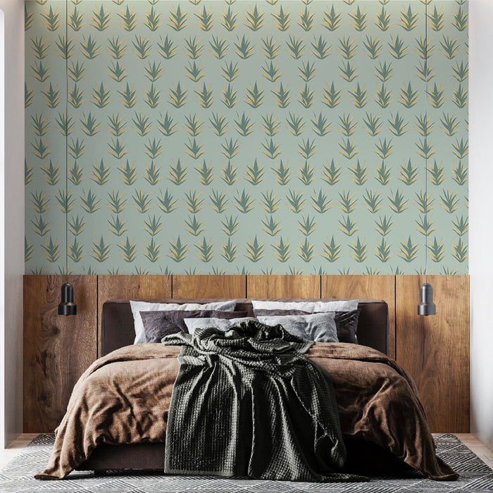 Une chambre moderne avec un papier peint aux motifs de feuilles stylisées vertes et dorées sur fond bleu clair, créant une ambiance apaisante et naturelle.