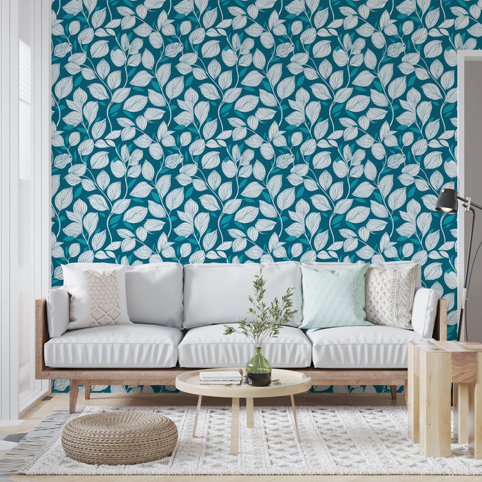 Un salon moderne avec un papier peint aux motifs de feuilles blanches sur fond turquoise, créant une ambiance fraîche et vivifiante.