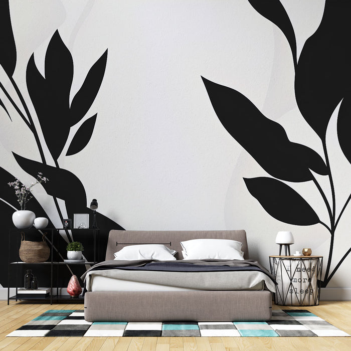 Une chambre moderne avec un papier peint graphique noir représentant de grandes feuilles sur fond blanc, créant une ambiance élégante et apaisante.