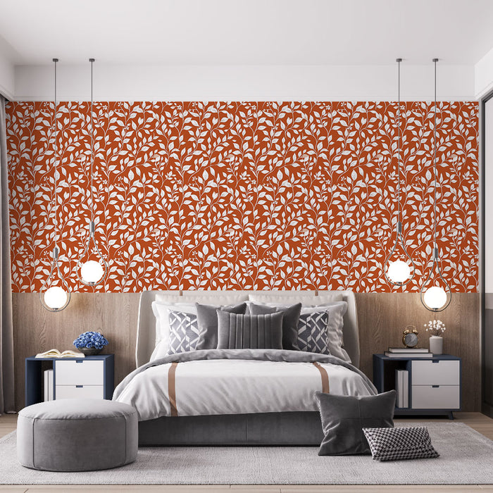 Une chambre moderne avec un papier peint aux motifs de feuillage blanc sur fond terracotta, créant une ambiance chaleureuse et accueillante.