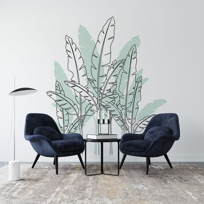 Une pièce moderne avec un papier peint représentant des feuilles de bananier stylisées en noir et vert pastel, créant une atmosphère tropicale et apaisante.
