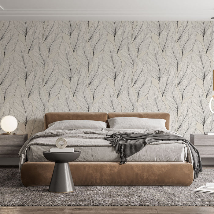 Une chambre moderne avec un papier peint aux motifs de grandes feuilles délicates en noir sur fond beige, créant une atmosphère apaisante et naturelle.