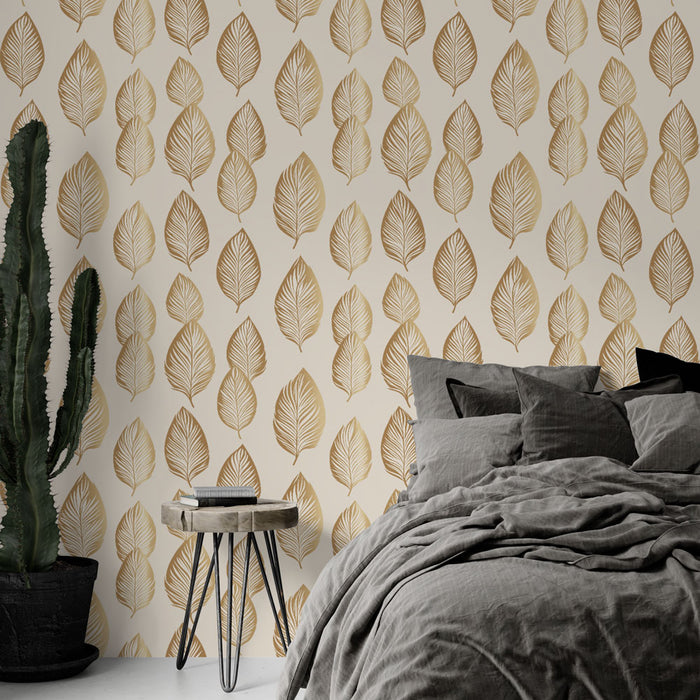 Une chambre moderne avec un papier peint aux motifs de feuilles dorées sur fond crème, créant une ambiance chaleureuse et naturelle.