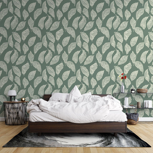 Une chambre apaisante avec un papier peint vert sauge orné de feuilles blanches délicates, créant une atmosphère naturelle et relaxante.