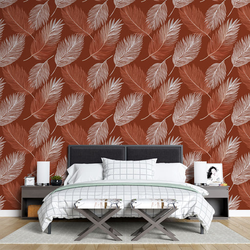 Une chambre moderne avec un papier peint aux motifs de feuilles blanches sur fond rouge terre, créant une ambiance chaleureuse et accueillante.