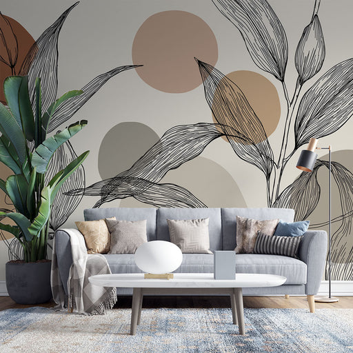 Un salon contemporain avec un papier peint aux motifs de feuilles stylisées en noir et des cercles aux teintes douces, créant une atmosphère apaisante et moderne.