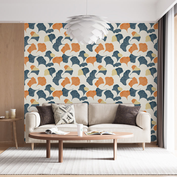 Un salon contemporain avec un papier peint aux motifs de feuilles stylisées dans des teintes orange, bleu et vert sur fond clair, créant une ambiance fraîche et dynamique.