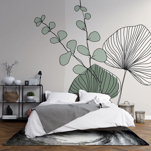 Une chambre moderne avec un papier peint illustrant des feuilles délicates en vert pastel et noir, créant une atmosphère apaisante et naturelle.