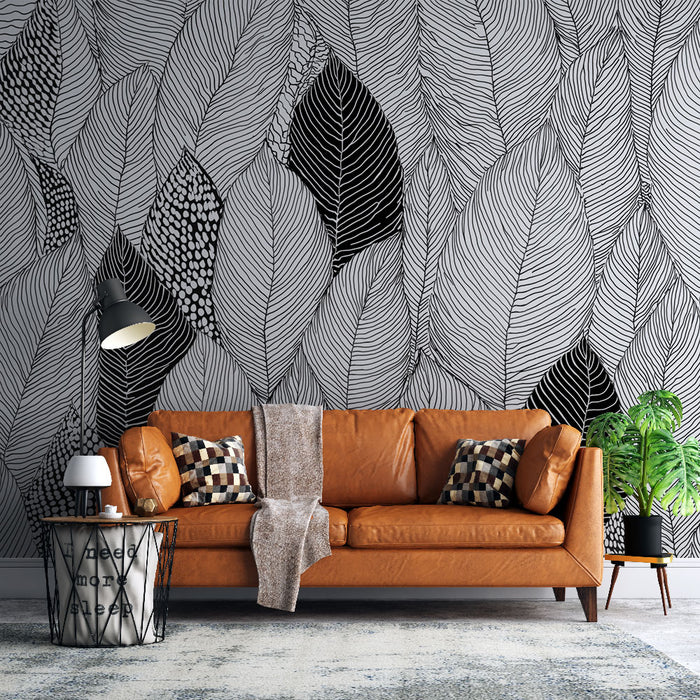 Un salon moderne avec un papier peint monochrome représentant de grandes feuilles stylisées en noir et blanc, créant une ambiance artistique et dynamique.