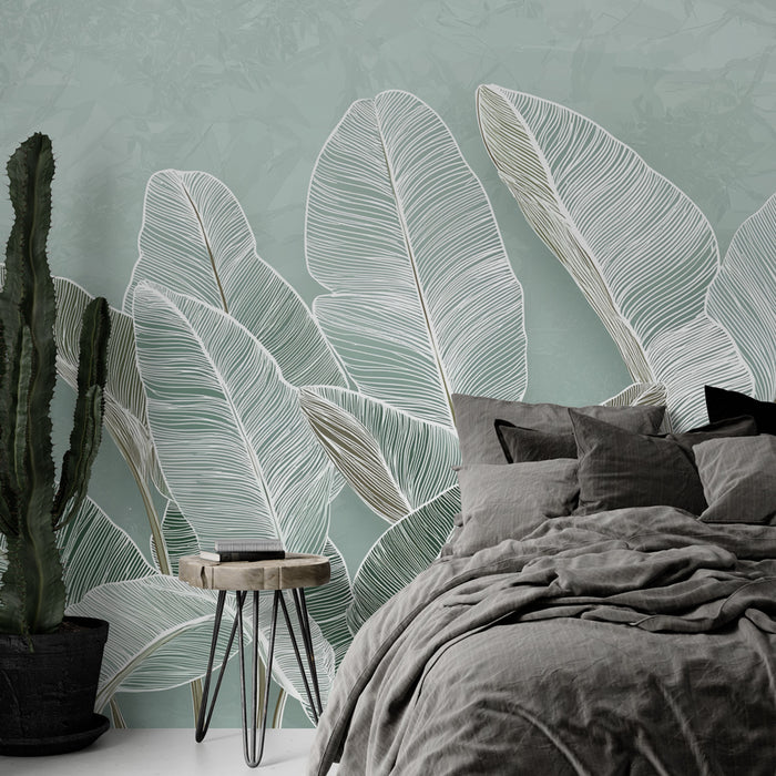 Une chambre moderne avec un papier peint représentant de grandes feuilles stylisées sur fond vert pâle, créant une ambiance apaisante et naturelle.