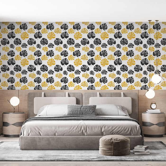Une chambre moderne avec un papier peint aux motifs de feuilles noires et jaunes sur fond blanc, créant une atmosphère dynamique et chaleureuse.