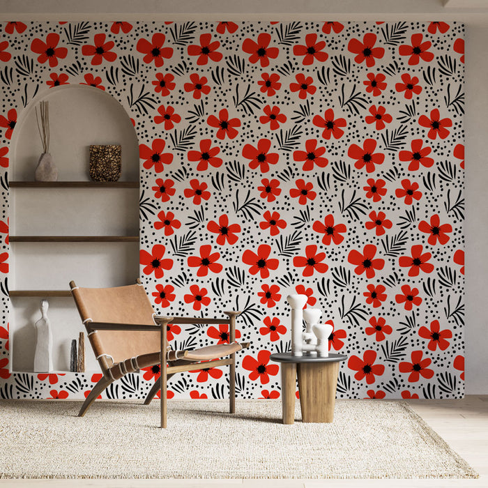 Une pièce lumineuse avec un papier peint floral aux motifs rouges et noirs sur fond blanc, créant une ambiance joyeuse et dynamique.