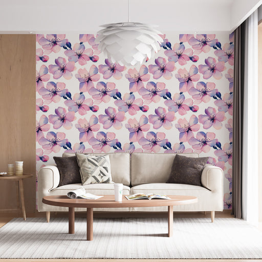 Un salon lumineux avec un papier peint floral aux teintes douces de rose et violet, créant une ambiance romantique et apaisante.