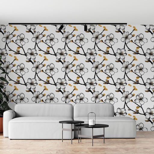 Un salon moderne avec un papier peint floral noir et blanc orné de fleurs délicates et de touches dorées, créant une ambiance élégante et apaisante.