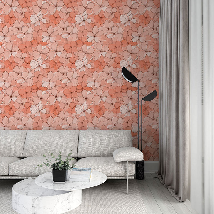 Un salon lumineux avec un papier peint floral aux teintes corail et beige, créant une atmosphère douce et accueillante.