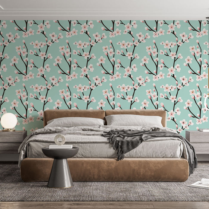 Une chambre moderne avec un papier peint floral aux fleurs roses sur fond vert menthe, créant une atmosphère douce et apaisante.