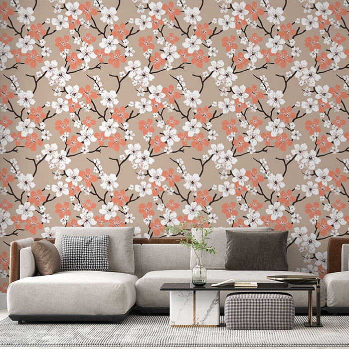 Un salon moderne avec un papier peint floral aux motifs de fleurs blanches et corail sur fond beige, créant une ambiance douce et accueillante.