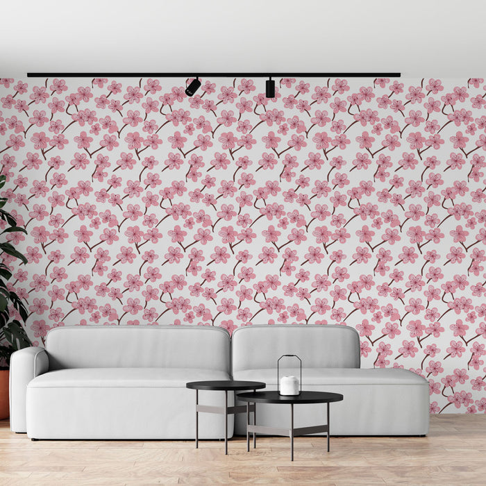 Un salon moderne avec un papier peint floral aux motifs de fleurs roses sur fond blanc, créant une ambiance douce et accueillante.