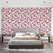 Une chambre moderne avec un papier peint floral aux motifs de branches noires ornées de fleurs rouges et roses sur fond blanc, créant une ambiance fraîche et vivifiante.