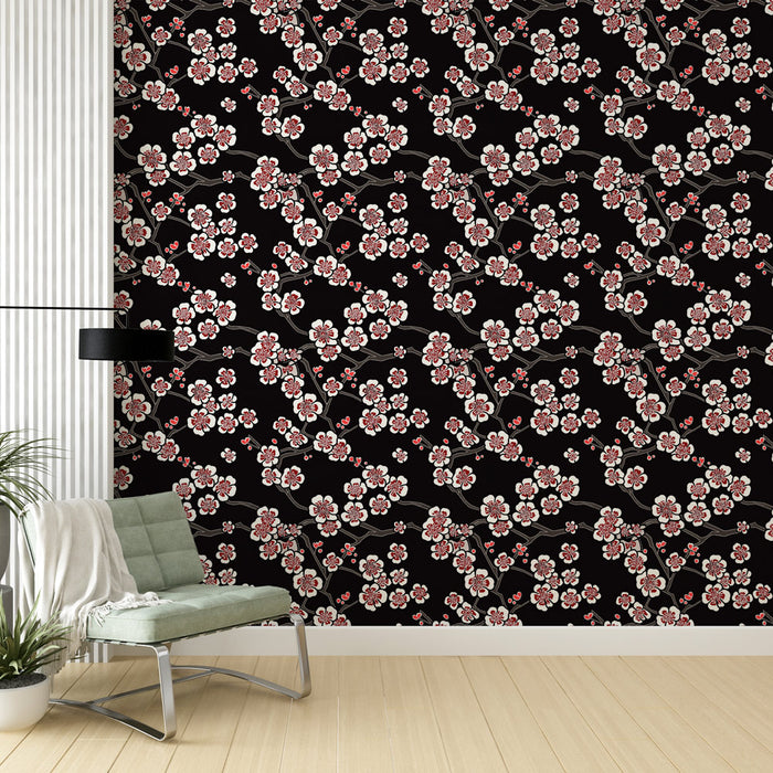Un salon moderne avec un papier peint floral noir orné de branches de cerisier et de fleurs roses, créant une atmosphère élégante et apaisante.