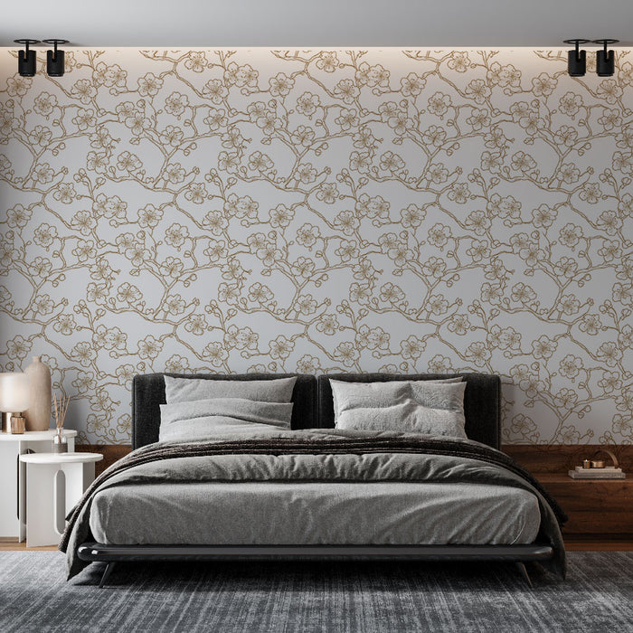 Une chambre moderne avec un papier peint floral beige et doré représentant des branches délicates, créant une atmosphère élégante et apaisante.