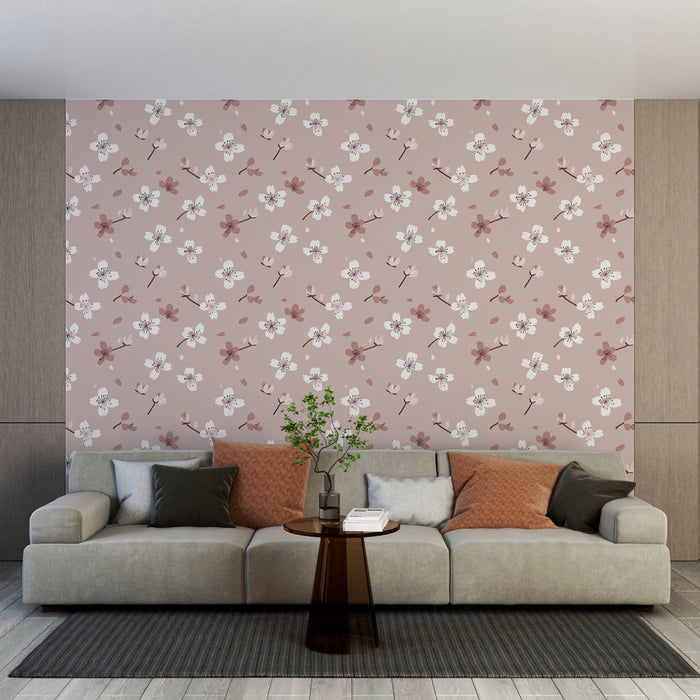 Un salon moderne avec un papier peint floral sur fond rose clair, orné de fleurs blanches et de touches de rouge, créant une atmosphère douce et accueillante.
