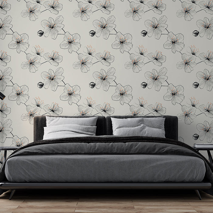 Une chambre moderne avec un papier peint floral monochrome aux délicates fleurs noires et touches orange sur fond clair, créant une atmosphère apaisante et élégante.