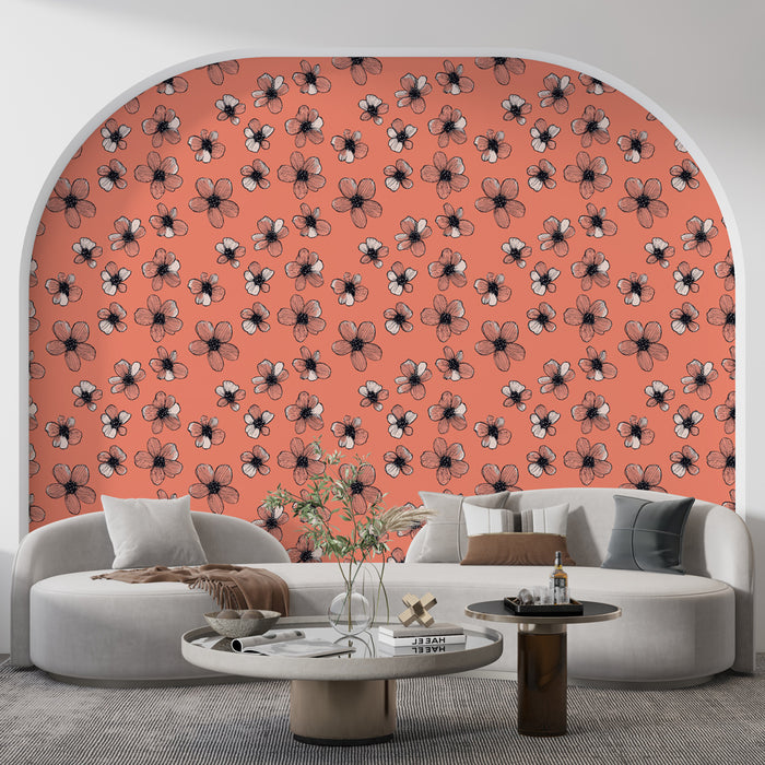 Un salon moderne avec un papier peint floral sur fond corail, présentant des fleurs noires et blanches, créant une atmosphère joyeuse et accueillante.