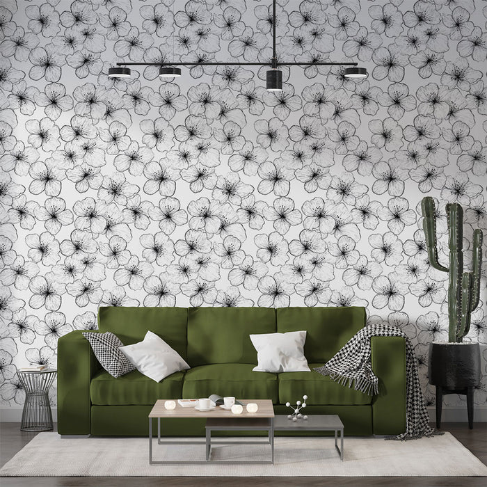 Un salon moderne avec un papier peint floral noir et blanc représentant des fleurs délicates, créant une atmosphère artistique et élégante.