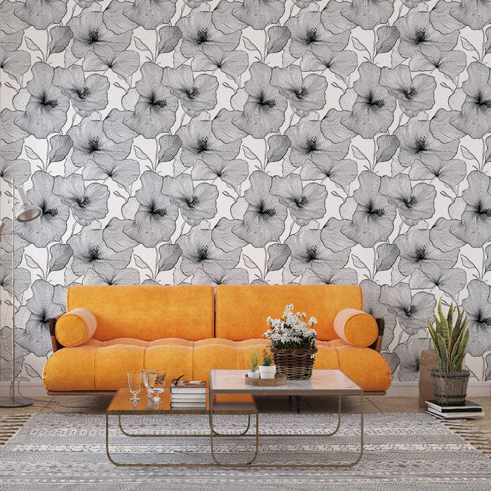 Un salon contemporain avec un papier peint floral noir et blanc représentant de grandes fleurs stylisées, créant une atmosphère élégante et artistique.