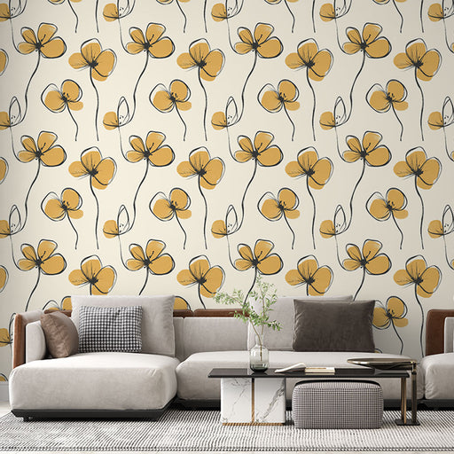 Un salon contemporain avec un papier peint floral aux motifs de fleurs jaunes et noires sur fond crème, créant une ambiance chaleureuse et accueillante.