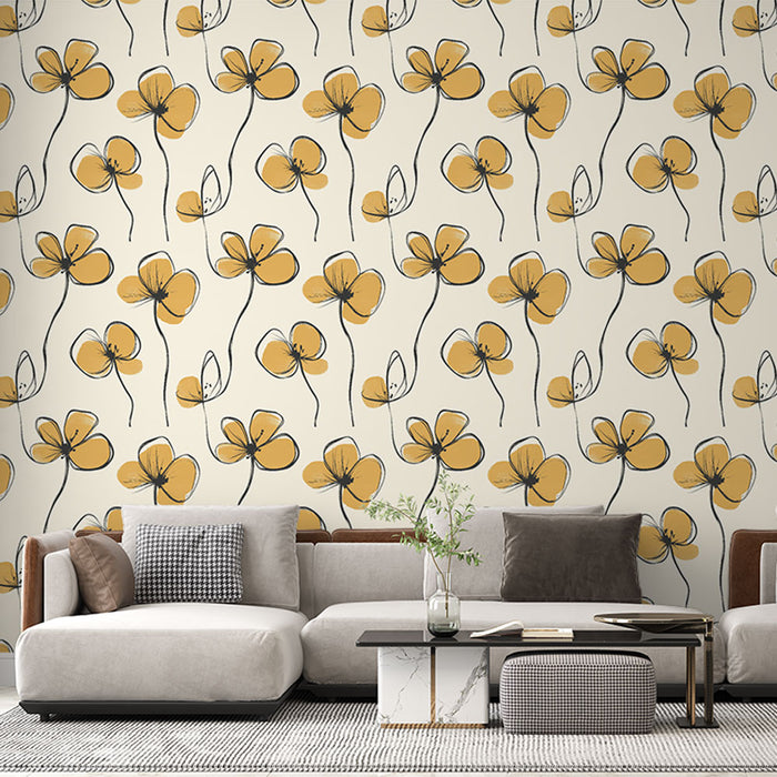 Un salon contemporain avec un papier peint floral aux motifs de fleurs jaunes et noires sur fond crème, créant une ambiance chaleureuse et accueillante.