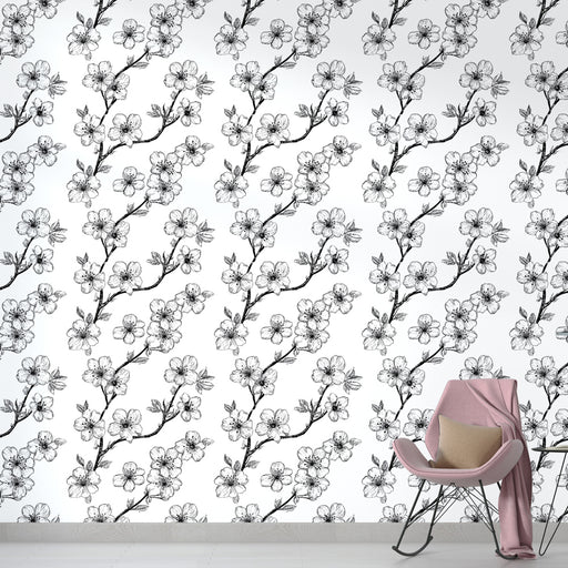 Une chambre moderne avec un papier peint floral noir et blanc représentant des branches de fleurs délicates, créant une ambiance élégante et apaisante.
