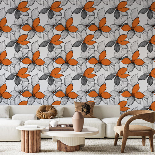 Un salon contemporain avec un papier peint floral aux motifs orange et noir sur fond blanc, créant une ambiance dynamique et chaleureuse.
