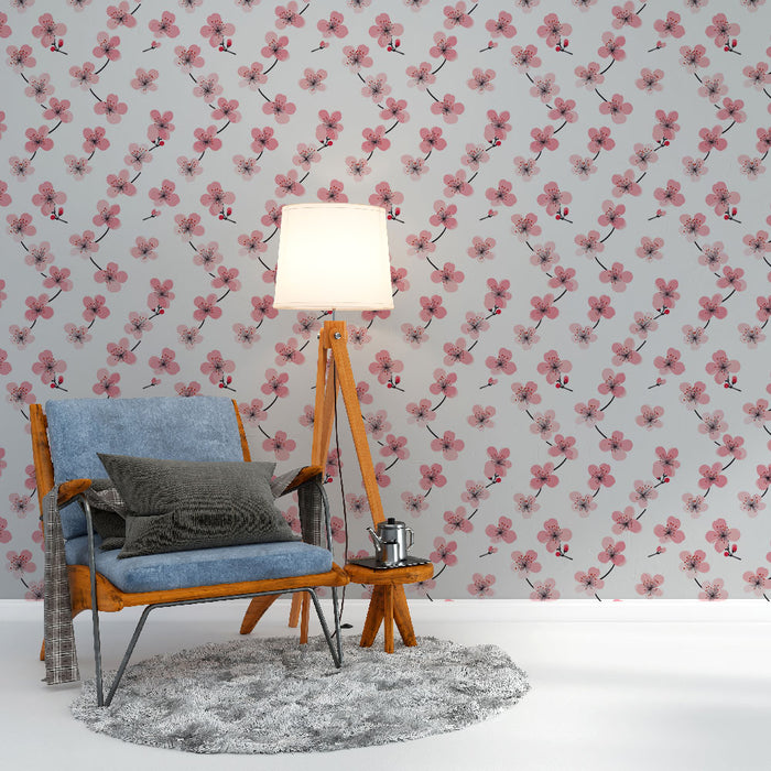 Une chambre lumineuse avec un papier peint floral aux motifs de fleurs roses délicates sur fond clair, créant une atmosphère douce et apaisante.