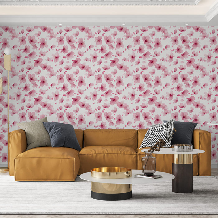 Un salon chaleureux avec un papier peint floral aux motifs de fleurs roses délicates sur fond blanc, créant une atmosphère douce et accueillante.