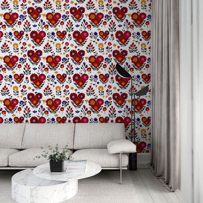 Un salon moderne avec un papier peint aux motifs floraux colorés et des cœurs rouges sur fond blanc, créant une atmosphère joyeuse et chaleureuse.
