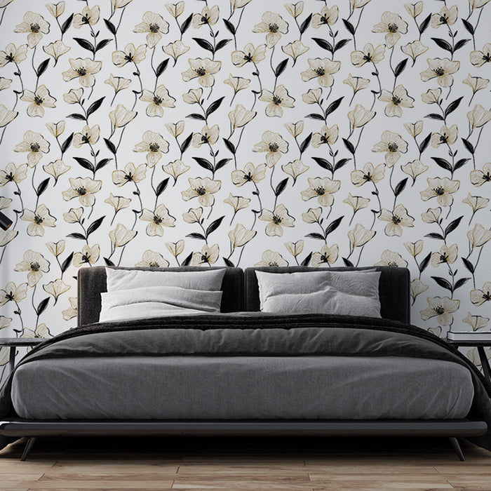 Une chambre moderne avec un papier peint floral noir et blanc aux délicates fleurs dorées, créant une atmosphère élégante et apaisante.