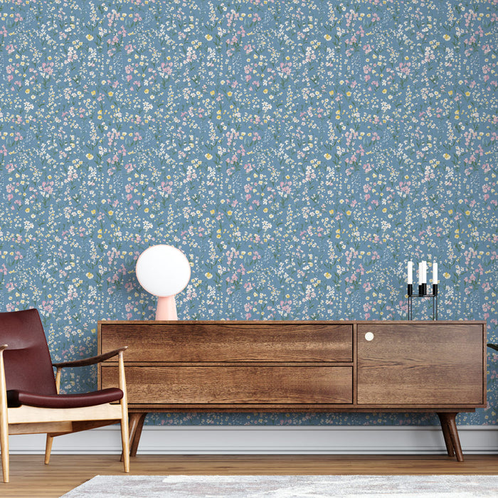Une pièce moderne avec un papier peint floral bleu orné de petites fleurs colorées créant une ambiance fraîche et accueillante.