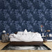 Une chambre apaisante avec un papier peint floral bleu nuit aux motifs de feuilles délicates, créant une atmosphère élégante et sereine.